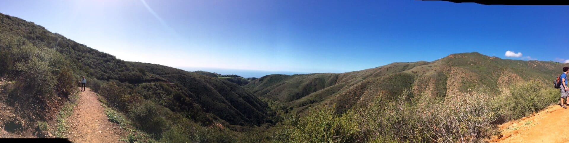 A view of the ocean and mountains from above.