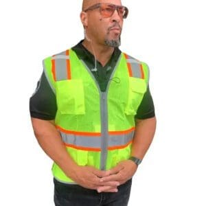 A man in safety vest with his hands on his hips.